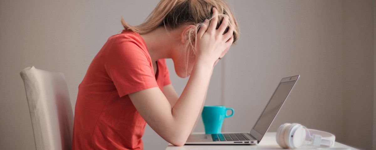 pexels-photo-3755761-3755761 Young woman feeling stressed while studying at home with a laptop and coffee cup.